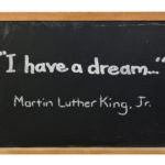 Cartoon of a chalkboard with the words “I have a dream…” written on it