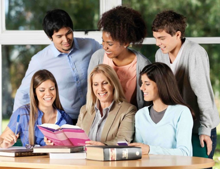 A group of students reading a book together