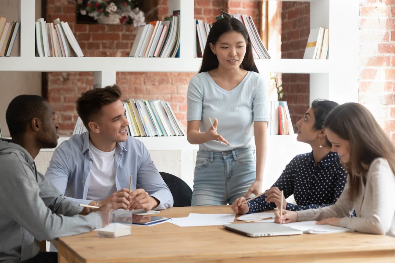 A group of high school students at a table working together