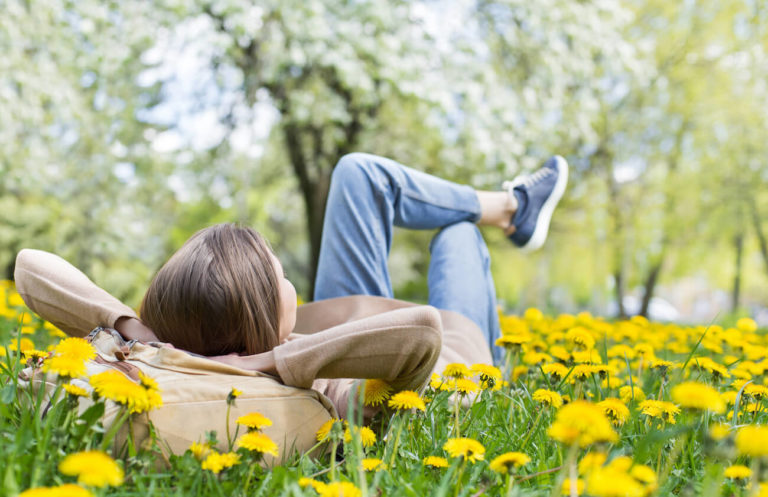 Woman laid back and relaxing in the grass