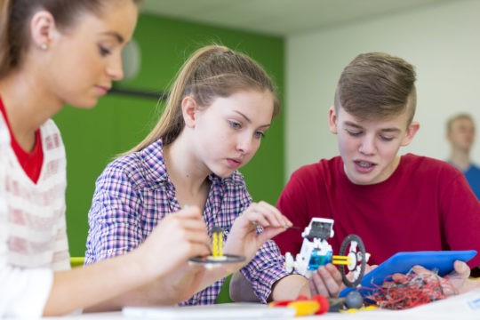 Group of students working together on a robot project.