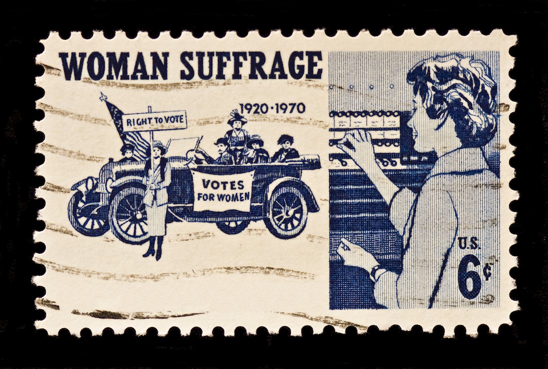 An old stamp showing women protesting against inequality and fighting for their right to vote